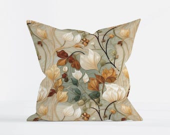 May include: A square throw pillow featuring a botanical pattern with white, cream, and rust-colored leaves and flowers on a sage green and beige background. The design includes thin, dark, winding stems that connect the various floral elements.