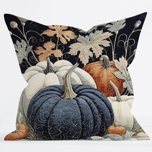 May include: A square throw pillow featuring a dark background with a pattern of pumpkins in shades of navy blue, white, and orange. The design includes intricate swirling line details on the pumpkins and light-colored foliage and vine accents.