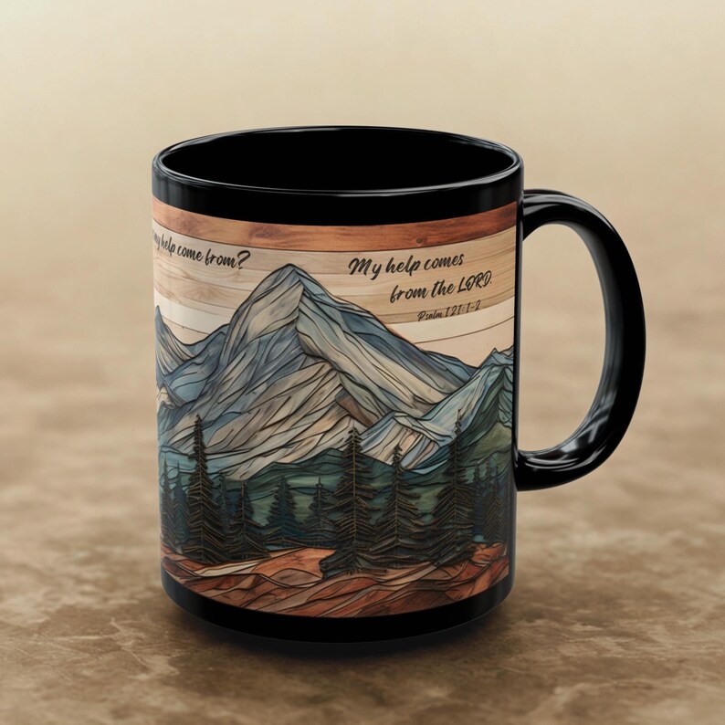 May include: A black ceramic mug featuring a wrap-around graphic of a mountain range and pine forest over a wood-grain background. The text reads, "Where does my help come from? My help comes from the LORD. Psalm 121:1-2" in a black script font.