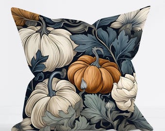 May include: A square throw pillow featuring a dark navy background with a repeating pattern of cream-colored pumpkins, one central orange pumpkin, and intricate, muted blue-green foliage and floral elements throughout the design.