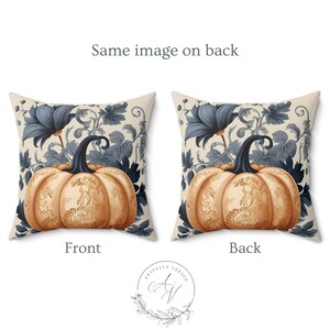 May include: A square throw pillow featuring a pumpkin with intricate orange and gold filigree patterns, set against a background of dark blue floral vines and leaves. The design is identical on both the front and back sides of the pillow.