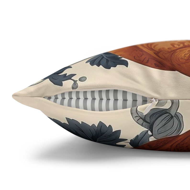 May include: A throw pillow featuring a cream-colored fabric with a dark gray botanical leaf pattern and a section of brown wood-grain texture. The pillow includes a white zipper closure revealing a gray and white striped fabric lining inside.