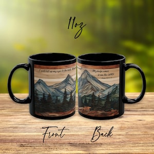 May include: Two black 11oz ceramic mugs featuring a mountain landscape graphic with a wood grain background. The text reads: I will lift up my eyes to the hills. Where does my help come from? My help comes from the LORD. Psalm 121:1-2.