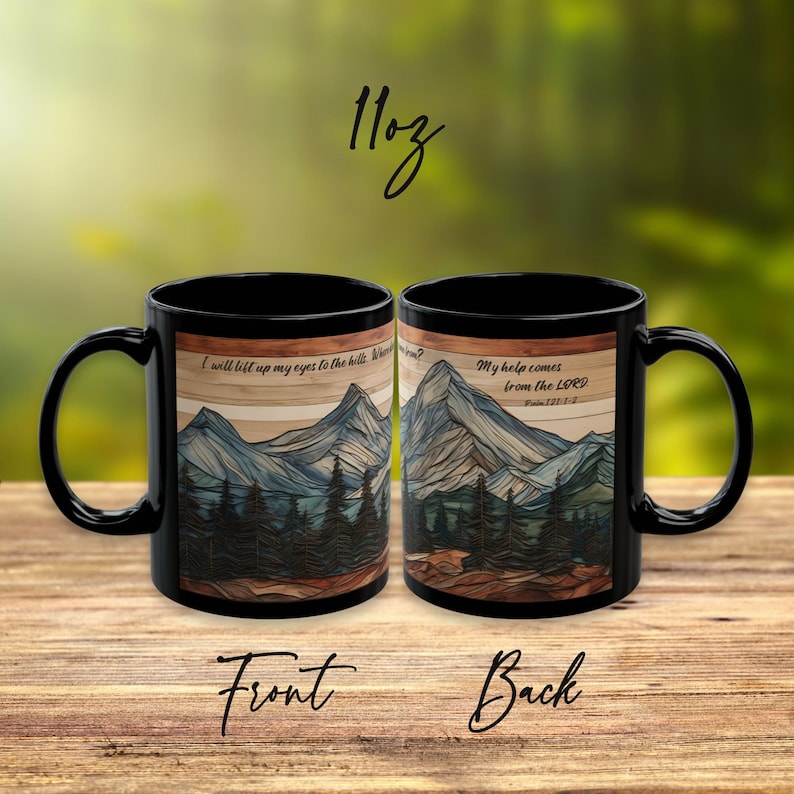 May include: Two black 11oz ceramic mugs featuring a mountain landscape graphic with a wood grain background. The text reads: I will lift up my eyes to the hills. Where does my help come from? My help comes from the LORD. Psalm 121:1-2.