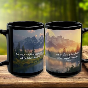 May include: Two black coffee mugs with a mountain scene and a quote from Isaiah 54:10. The quote reads "For the mountains may depart and the hills be removed: but my loving kindness will not depart from you."