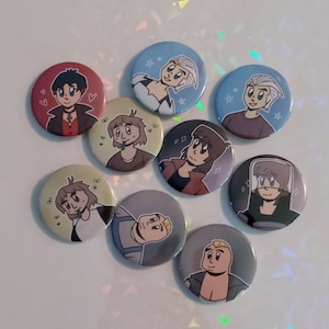 May include: Eight round pinback buttons with different cartoon characters. The characters are drawn in a colorful anime style. The buttons are all 1 inch in diameter.