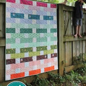 May include: A colourful quilt pattern called "Thread Count" by Amy Gibson. The quilt is made with a variety of fabrics in shades of pink, green, blue, and white. The quilt is fat quarter friendly and is numbered #135.