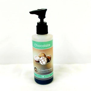 May include: A clear plastic bottle with a black pump dispenser filled with dark brown liquid. The label reads "Chocolate" and features a graphic of chocolate candies. The label also includes the text "Weldon Flavorings" and "Flavors 118 Servings".