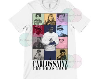 Peut inclure: T-shirt blanc avec un collage de photos d'un pilote de course automobile. Les photos sont disposées en grille et montrent le pilote portant différentes combinaisons de course et casques. Le texte "Carlos Sainz The Eras Tour" est imprimé sous les photos.
