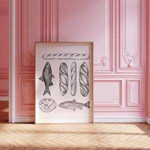 Puede incluir: Una ilustraci&oacute;n en blanco y negro de una baguette, pescado y pan sobre un fondo blanco. La ilustraci&oacute;n est&aacute; enmarcada y colgada en una pared rosa.