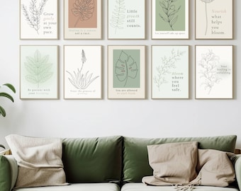 May include: A living room scene featuring a green velvet sofa, a wooden coffee table, and a large potted plant. The wall displays a collection of framed botanical art prints with inspirational quotes and line drawings of plants.