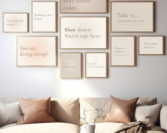 May include: A living room scene featuring a beige sofa with decorative pillows and a wooden coffee table. Above the sofa, framed prints with inspirational quotes like "Choose calm over chaos today" and "You are doing enough" are displayed.