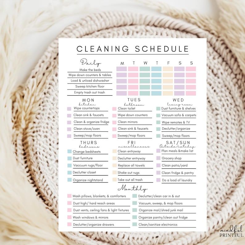 May include: A printed cleaning schedule with pastel colour-coded sections for daily, weekly, and monthly tasks. The schedule includes tasks like making beds, cleaning bathrooms, and organising. The text "CLEANING SCHEDULE" is at the top.