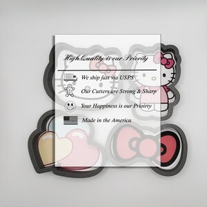 May include: A set of cookie cutters featuring Hello Kitty, a heart, and a bow. The cutters are made of metal and have a black finish. The text "High Quality is our Priority" is printed on the background.