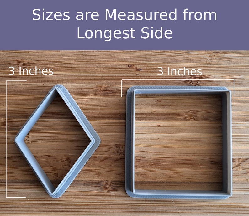 May include: Two cookie cutters on a wooden surface. The cookie cutters are 3 inches in size. One is a square shape and the other is a diamond shape.