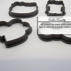 May include: Three gray plastic cookie cutters, one shaped like a heart, one shaped like a cloud, and one shaped like a rectangle. The text "Cutter Quality" is printed on a white label, with the text "All Cutters are made with a strong base to allow for a sturdy cookie cutter".
