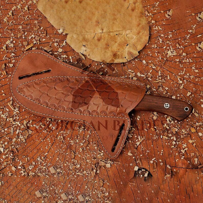 May include: A brown leather sheath with a decorative pattern and a brown wooden-handled knife with a black blade.