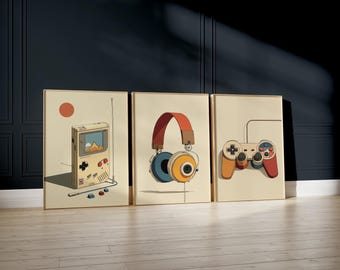May include: Three framed art prints featuring retro gaming themes. The prints depict a handheld game console, headphones, and a game controller, all in a vintage cartoon style with a beige background and a warm color palette.
