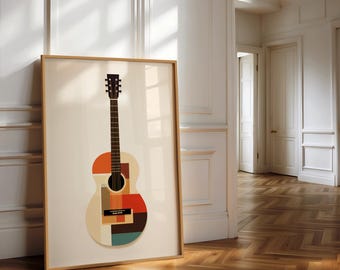 May include: A framed art print featuring a geometric design of an acoustic guitar. The guitar's body is composed of colorful shapes in orange, red, beige, and teal. The frame is a light wood color, and the artwork leans against a white wall.