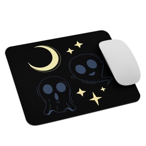 May include: Black mouse pad with a crescent moon, stars, and two ghosts in a cartoon style. The ghosts are blue and white.