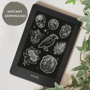 May include: A black and white digital illustration of a crow, skull, heart, snake, butterfly, rose, crystal, and a house. The illustrations are on a black background and are displayed on a Kindle e-reader.