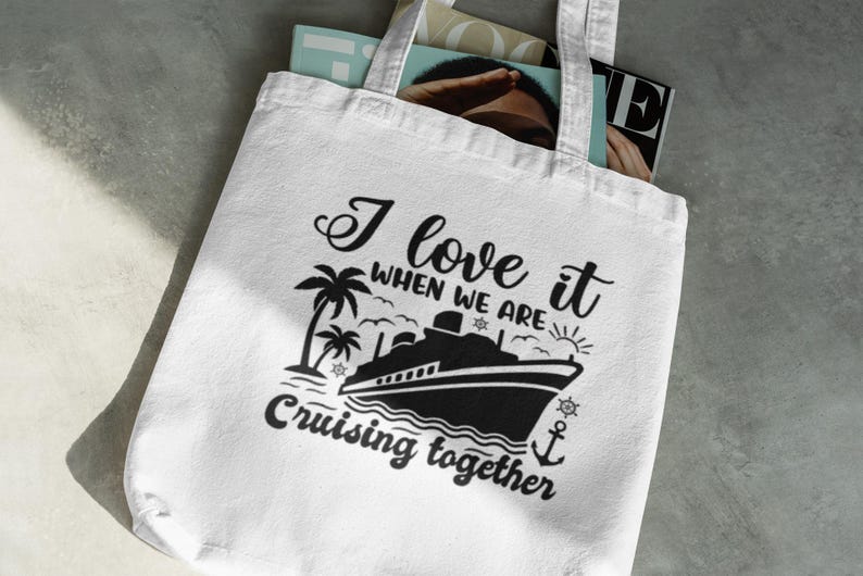 May include: White tote bag with black text and a graphic of a cruise ship and palm trees. The text reads "I love it when we are cruising together."
