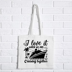 May include: White tote bag with black text and a silhouette of a cruise ship. The text reads "I love it when we are cruising together".