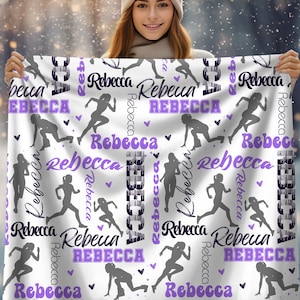 May include: White fleece blanket with a repeating pattern of a running female figure and the name "Rebecca" in various fonts and colors. The name "Rebecca" is in purple, black, and white. The running figure is in gray. The background is white.