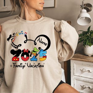 a woman in a mickey mouse shirt on a bed