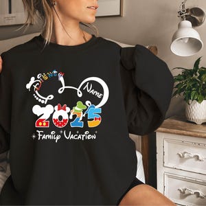 a woman wearing a mickey mouse family vacation shirt