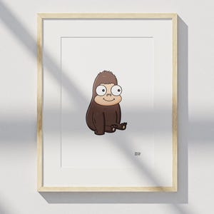 May include: A framed art print featuring a cartoon illustration of a brown, furry creature with large, wide eyes and a small smile, sitting upright. The creature has a light tan face and dark brown fur. The text DALE ARTIST is visible in the bottom right.