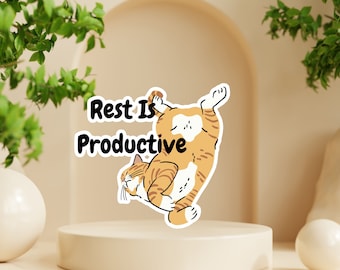 May include: A sticker with a cartoon orange tabby cat curled up in a ball. The text "Rest Is Productive" is above the cat.