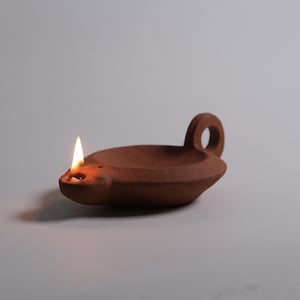 May include: A set of three ceramic mugs with a speckled, matte finish. The mugs are in shades of cream, light grey, and dark grey. Each mug has a simple, minimalist design and a rounded handle.