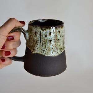 Handmade Black Stoneware Mug: Beige & Brown Drip Glaze, Speckled Ceramic