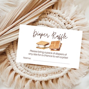 May include: White card with brown text that says "Diaper Raffle". Two watercolor illustrations of s'mores are above the text. Below the text is a line that says "Please bring a pack of diapers of any size for a chance to win a prize!" and a line that says "Name:"