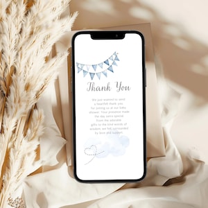 May include: A blue and white thank you card with a string of blue and white pennants at the top. The card says "Thank You" and includes a message expressing gratitude for attending a baby shower. The card also features a blue watercolor cloud with a heart-shaped airplane.