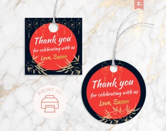 May include: Two gift tags with a red circle and the text "Thank you for celebrating with us Love, Susan". The tags have a black border and bamboo and lantern designs. One tag is square, the other is round.