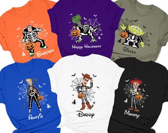 May include: Set of six t-shirts featuring characters from the Toy Story franchise dressed as skeletons holding pumpkins. The shirts are in various colors, including orange, purple, green, blue, white, and black. The text on the shirts includes "Brother", "Happy Halloween", "Sister", "Auntie", "Daddy", and "Mommy".