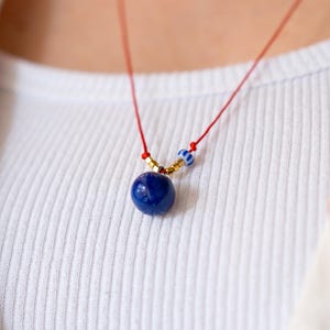 Red String Necklace: Blue Ceramic Bead, Gold Accents, Adjustable Cord