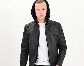 May include: Black leather jacket with a hood. The jacket features a zip-up front, quilted shoulder and arm details, and two chest pockets. The model is wearing a white t-shirt underneath.