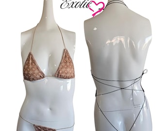 May include: A brown bikini with a patterned top and a string bottom. The bikini top has adjustable straps and a halter neck style. The bikini bottom has a low rise and a string tie at the sides.