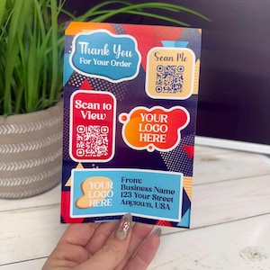 May include: A colorful business thank you card with the text "Thank You For Your Order", "Scan Me", "Scan to View", and "Your Logo Here". The card also includes the business name, address, and a QR code.