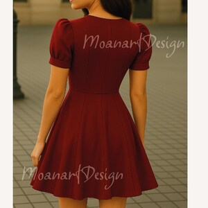 May include: A burgundy short-sleeved dress with a fitted bodice and a flared skirt. The dress has a V-neckline and a button closure at the front. The dress is made of a smooth, lightweight fabric.