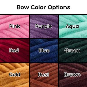 May include: A grid of nine color swatches of plush yarn labeled Bow Color Options. The colors are pink, purple, aqua, red, blue, green, gold, rust, and brown. Each square displays a close-up texture of the soft, thick yarn in its respective hue.