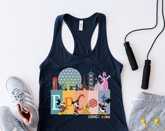 May include: A navy blue tank top with a colorful graphic of the Epcot logo, Mickey Mouse characters, and the text "Since 1982". The tank top is paired with gray athletic shorts, a jump rope, and gray running shoes.