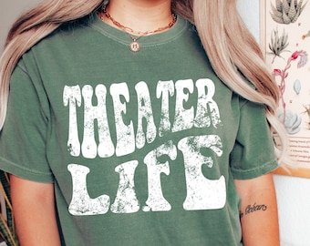 May include: A green t-shirt with a white distressed graphic that says "Theater Life".