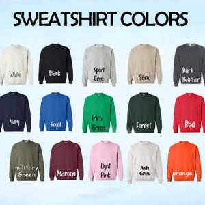 May include: A chart showing 18 different sweatshirt colors. The colors include white, black, sport grey, sand, dark heather, navy, royal, Irish green, forest, red, military green, maroon, light pink, ash grey, and orange.