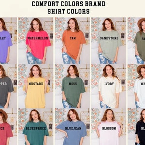 May include: A collage of 15 different colored t-shirts, each with a different color name printed on the front. The colors include violet, watermelon, yam, sandstone, sage, pepper, mustard, moss, ivory, white, brick, bluesprue, bluejean, blossom, and black.