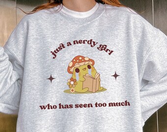 May include: Gray sweatshirt with a mushroom graphic and the text "just a nerdy girl who has seen too much".