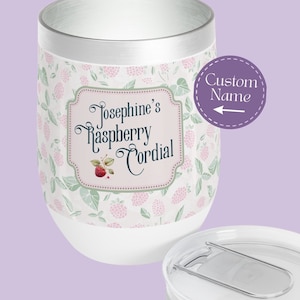 May include: White stainless steel tumbler with a silver lid and a pink and green raspberry design. The tumbler has a custom name, "Josephine's Raspberry Cordial", printed on it.